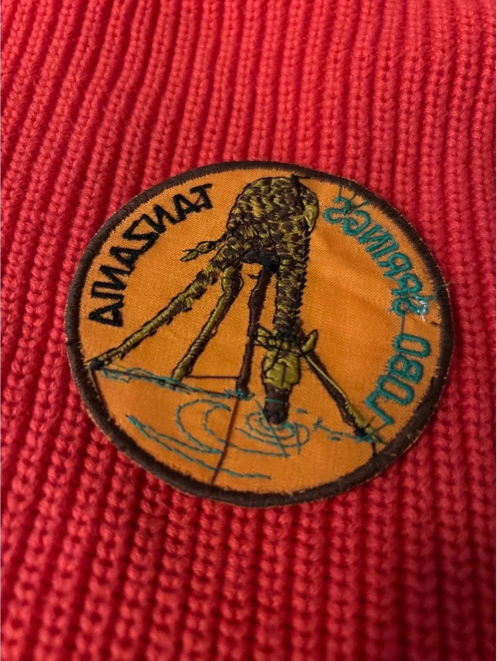 Tanzania Lobo Springs Embroidered Patch on Red Knit Fabric